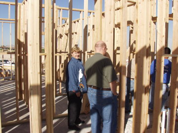 Kathy and JD look on as Jack tells the concrete guy what to do